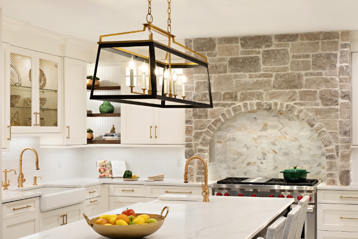 One of the homeowners' primary design requests was to incorporate a hearth into the kitchen. In response, Aparna designed a sophisticated stone-clad mantel that elegantly frames the expansive 48” Wolf range. The backsplash features Calacatta picket tiling installed horizontally, giving the space a timeless focal point.