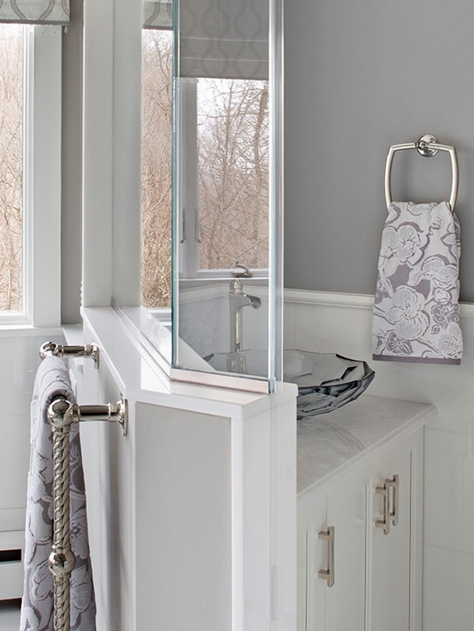 The toilet room also includes a lovely Kohler Briolette Faceted Glass Vessel Sink and elegant Brizo Rook Lav Faucet.