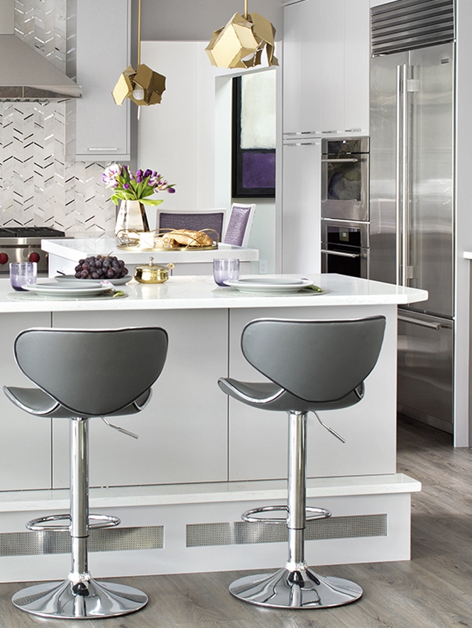 The original kitchen was one of the coldest spaces in the home.  We had to get creative to bring in the heat so Aparna designed a footrest for the peninsula with silver-toned metallic mesh that blends harmoniously with the geometry and aesthetics of the room.